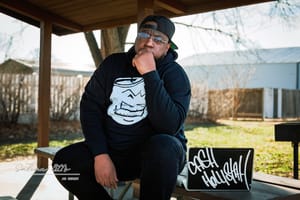 One Mic, One City: Cash Hollistah and the Art of Staying Local